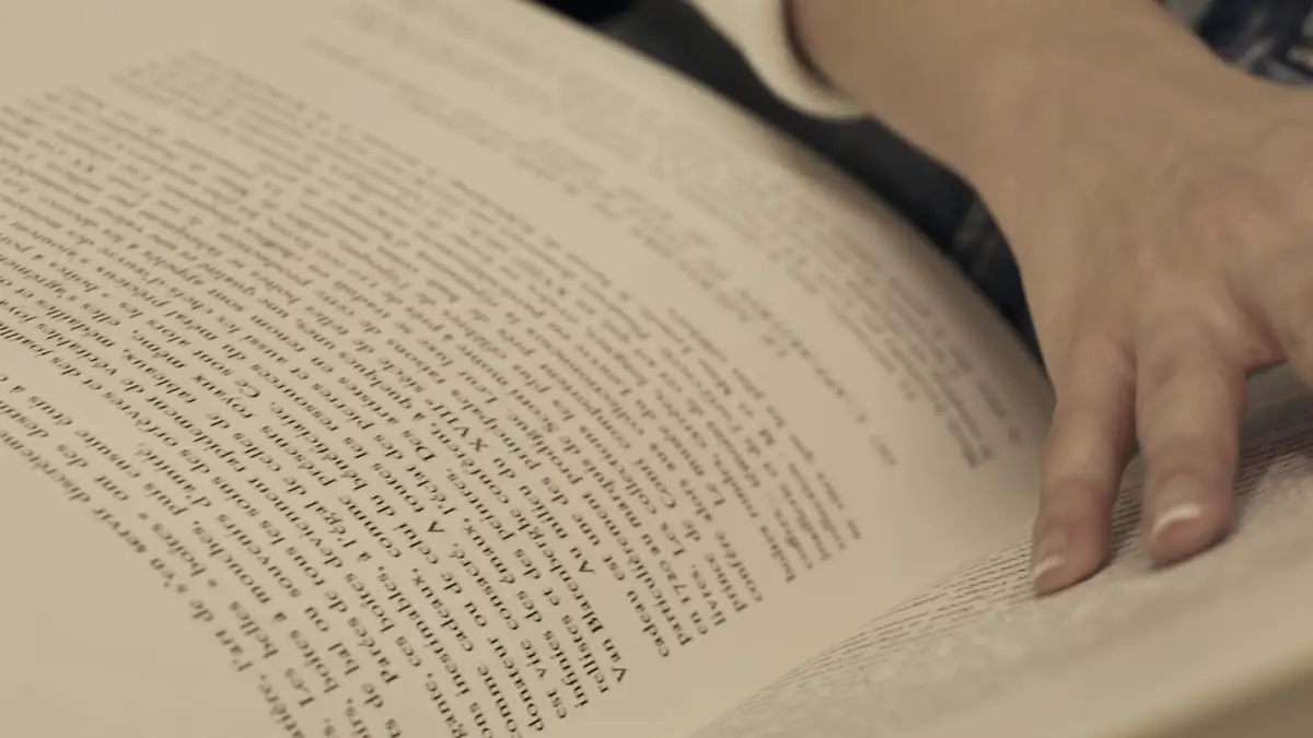 Hands turning the pages of a book